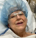 A companion smiling from a hospital bed