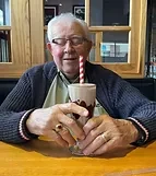 A companion enjoying a milkshake
